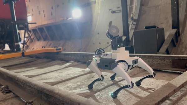 Quadruped robot on rail tracks inside a rail tunnel for patrol